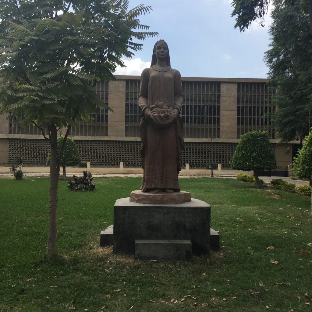 This image has an empty alt attribute; its file name is Statue-of-a-Peasant-Woman-in-the-Museum-Gardens-1024x1024.jpg